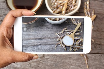 Canvas Print - Taking a photo of fish sauce with smart phone