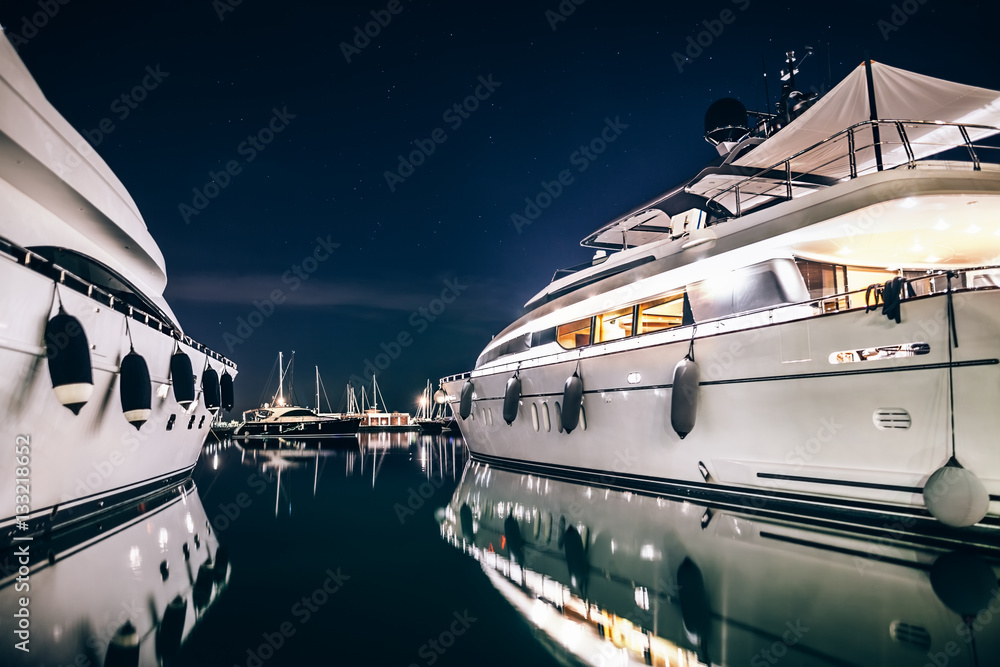 Luxury yachts in La Spezia harbor at night with reflection in wa - obrazy, fototapety, plakaty 
