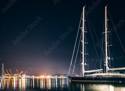 Fotografie, Obraz Luxury yacht in La Spezia at night with reflection in water