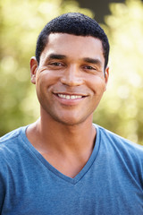 Wall Mural - Portrait of smiling young African American man, vertical