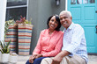 © Monkey Business - Senior couple sit on steps outside their house, close up