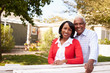 © Monkey Business - Senior black couple look to camera outside their new house