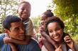 © Monkey Business - African American parents giving children piggyback rides