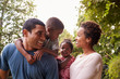 © Monkey Business - Young African American parents carrying children in garden