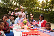 © Monkey Business - Multi generation black family having a 4th July garden party