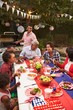 © Monkey Business - Multi generation black family at 4th July barbecue, vertical