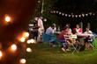 © Monkey Business - Multi generation black family enjoying a barbecue dinner