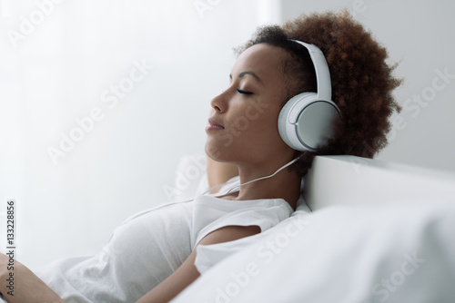 Woman relaxing and listening to music Poster Mural XXL