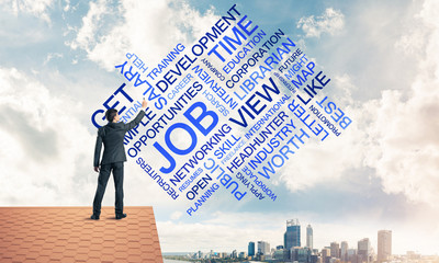 Young businessman standing on house roof and writing leadership 