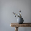 © Anna Cor - Vase on wooden table against gray wall