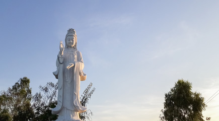 Statue of Guanyin with sky.