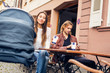 © nullplus - Young Parents With Baby Stroller Having Coffee At A Cafe