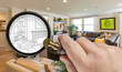 Hand Holding Magnifying Glass Revealing Custom Living Room Design Drawing and Photo Combination.