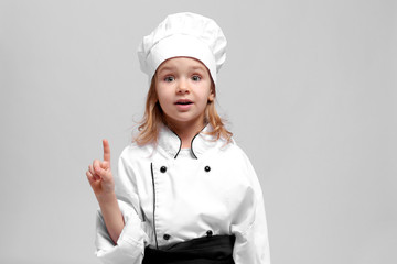 Sticker - Cute girl in chef uniform on light background