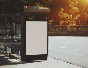 Wall Mural - City bus stop with empty mock up banner for your advertising, blank billboard with copy space area for your text message or promotional content, public information board in urban setting