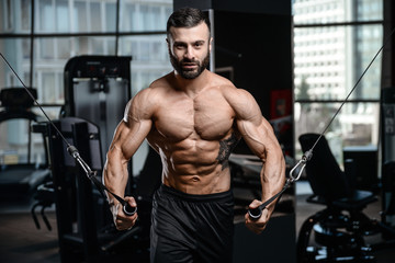 Fitness instructor handsome man in the gym gain muscle