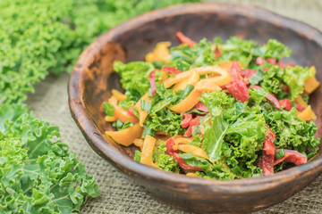 Fresh healthy raw nutritional salad with organic curly kale gree