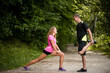 © Martinan - Happy couple doing warm-up exercises together outdoors