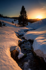 Wall Mural - last sunrays over mountains river in winter