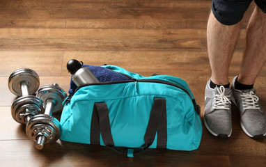 Canvas Print - Male legs and sport bag on the floor