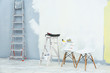 © Africa Studio - Ladder, paint and tools for making repair in empty room