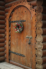 Floral Wreath With Beautiful Flowers Hanging On Vintage Wooden Door