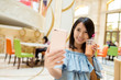 © leungchopan - Woman taking photo with her drink by mobile phone