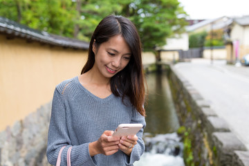 Wall Mural - Woman use of smart phone at Japanese old town