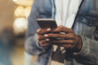 © A_B_C - Girl pointing finger on screen smartphone on background illumination bokeh light in night atmospheric city, hipster using in female hands and texting mobile phone, mockup glitter street, content
