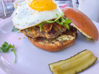 Hamburger with pickles in restaurant