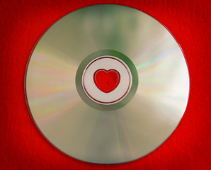 Valentine's day background - colorful CD disk with heart shape in the central part