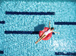 © Alena Ozerova - Woman relaxing with lilo in pool