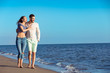 © FS-Stock - Couple walking on beach. Young happy interracial couple walking on beach.