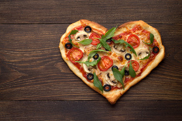 Wall Mural - Heart shaped pizza with chicken and mushrooms on dark wooden vintage background.