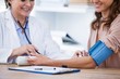 © WavebreakmediaMicro - Female doctor checking blood pressure of a patient
