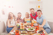 © Prostock-studio - Group of happy young people at dinner table, friends party
