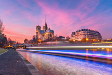 Wall Mural - Picturesque grandiose sunset over Cathedral of Notre Dame de Paris and luminous track from the boat, France