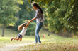 © BalanceFormCreative - Mother and daughter playing circling around at the park on beautiful morning.