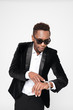 © Drobot Dean - Young african businessman wearing glasses looking at watch