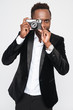 © Drobot Dean - Attractive young african businessman make a photo by his camera