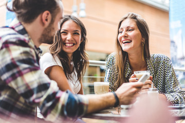 multiracial group of friends having a coffee together