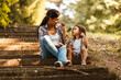 © BalanceFormCreative - Mother and daughter relaxing in park.She reading a fairytale to her daughter