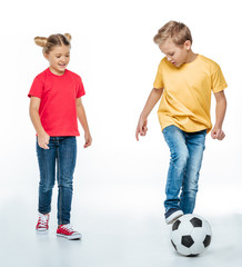 Wall Mural - siblings playing with soccer ball