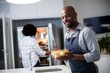 © WavebreakMediaMicro - Portrait of man holding bowl of salad while woman opening a refr