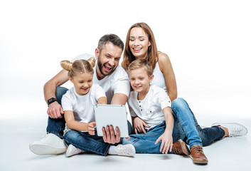 Wall Mural - Smiling family using digital tablet