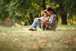 © BalanceFormCreative - Mother and daughter relaxing in park. She's reading a fairy tale to her daughter.