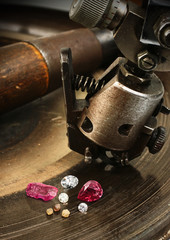 faceting gemston, big diamond with jewelery equipment on backgro