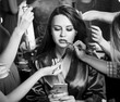 Beautiful plus-size model preparing for a runway show in dress and with make up. Backstage