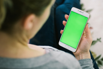 Poster - beautiful girl holding a smartphone in the hands of a green screen green screen, hand of man holding