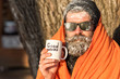 © be free - Man in blanket with cup